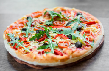 Pizza Margherita or Margarita with Mozzarella cheese, tomato, olive. Italian pizza on wooden background