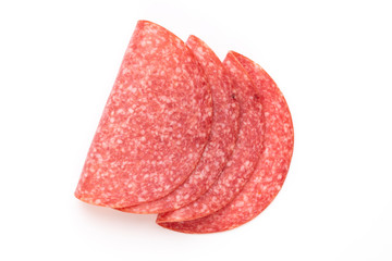 Salami slices on white background.