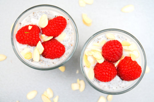 chia pudding with raspberries in a small glass bowl