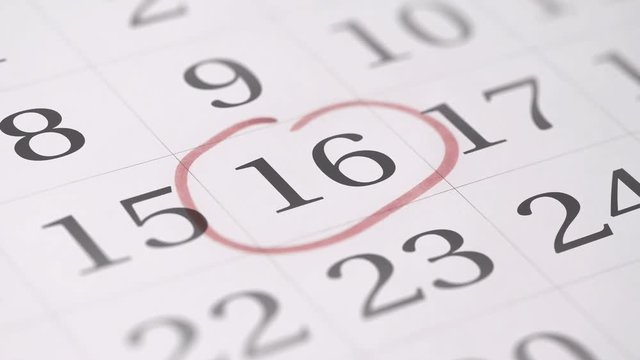 Marking the sixteenth 16 day of a month in the calendar with a red marker