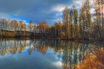 Autumn landscape sunny warm day in the forest by the river