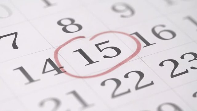 Marking the fifteenth 15 day of a month in the calendar with a red marker