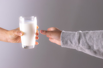 Drink and health care concept. , Closeup woman hand giving glass of milk to child.