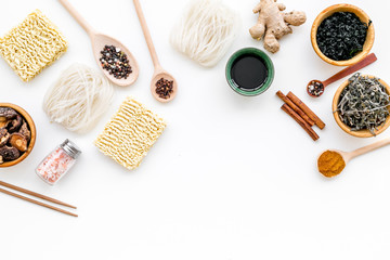 Chinese and Japanese food cooking with ginger, spices and noodles on white background top view mockup