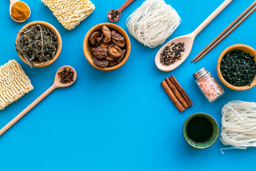 Geometric design with Chinese, Japanese products, noodles, weeds. spices, mushrooms on blue background top view mockup