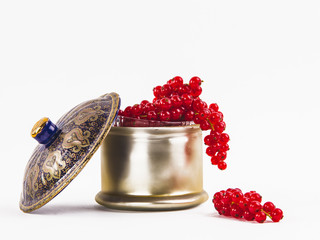 Beautiful red cranberries hanging over the edge of a luxury bowl.