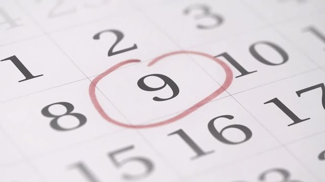 Marking the nineth 9 day of a month in the calendar with a red marker