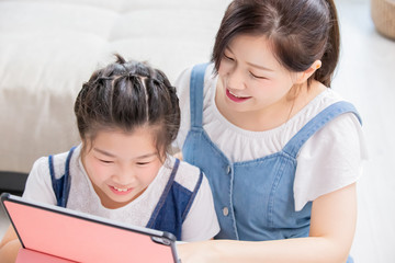 Mom and daughter use tablet