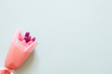 Bouquet of stabilized flowers on blue background