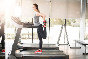 Fototapeta premium Pretty young sporty woman is warm up in gym, Healthy lifestyle