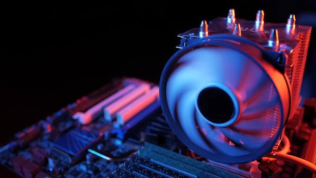 rotating processor CPU fan installed on the motherboard on a black background