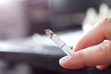 Woman smoking a cigarette. Cigarette smoke spread.