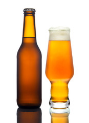 A glass of light beer and bottle on a white background, isolated