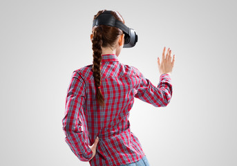 Girl in mask experiencing virtual reality as new entertainment device