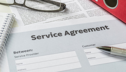 A Service agreement with a pen on a desk