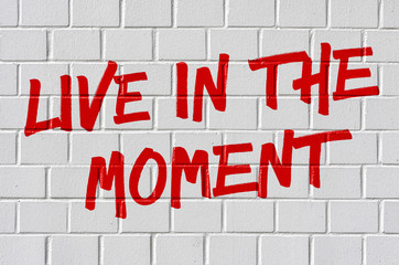 Graffiti on a brick wall - Live in the moment