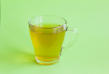 glass Cup with green tea on green background