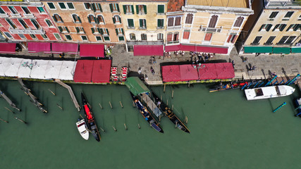 Fototapeta na wymiar Aerial drone top view photo of iconic and unique colourful Gondolas in Grand Canal near Rialto bridge, Venice, Italy