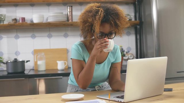 Attractive young African woman using laptop computer