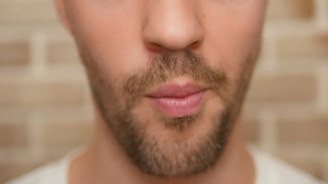close-up. male mouth. man eating french fries.