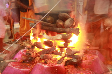 Bhadrak, Odisha, India. 13th April, 2019.Homa is concluded with a Purnahuti, Aarthi and offering the Thamboolam and cuconuts to Lord Agni. Priests continue with the last of the mantras. motion blur