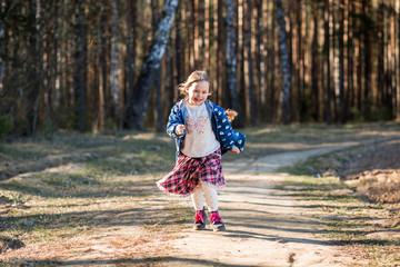 Fototapeta premium little girl in nature have fun and dance