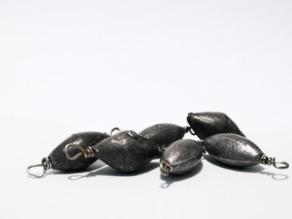 Closeup and macro shot of weighted fishing equipment with white background. 