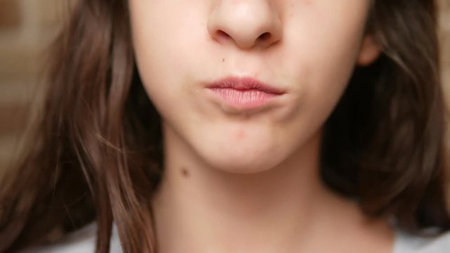 close-up. child's mouth. teenager eats french fries.