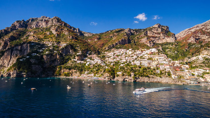 Fototapeta na wymiar ship departs from the pier full tourist. Tourist Yacht Tour, water transport, traffic, license. rent vacation on the ship, boat. bay, beautiful sunny weather, vacation. aerial view Positano, Italy
