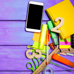 school supplies in the school desk, stationery, school concept, blue background, creative chaos, space for text, markers, pens, notepads, stickers. copyspace