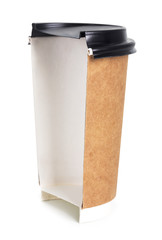 Takeaway coffee in a paper cup. Creative coffee advertising, paper cup in the cut. Advertising coffee.
