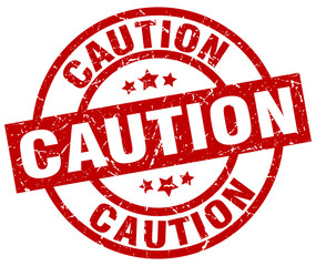 caution round red grunge stamp