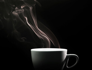 Fragrant coffee on a black background for your advertising. Smoke from hot coffee.