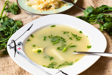 Asparagus soup, parsley and boiled asparagus on table.