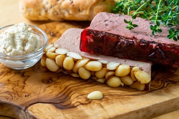 Two pieces of pate,horseradish, bread and herbs.