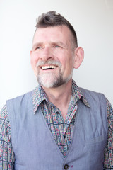Obraz premium smiling handsome grey-haired man in his 50s
