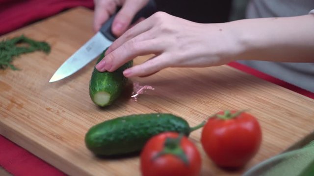 The chef cuts a cucumber on a bamboo Board, healthy eating, close-up, time lapse video, time lapse