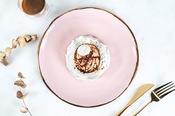 top view on healthy vegan dessert anna pavlova on white marble table with coffee and food tableware. Copy space for design. Fresh vegan raw dessert. Healthy food. meringue sweet cake