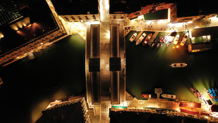 Aerial night shot of iconic illuminated Ponte Rialto or Rialto bridge crossing Grand Canal, Venice, Italy