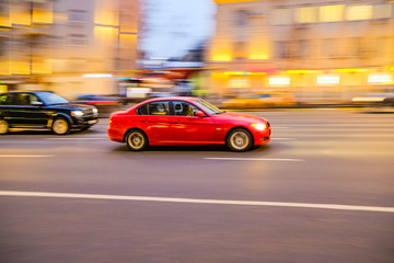 Car at high speed with a blurred image on the background of the city in the dark