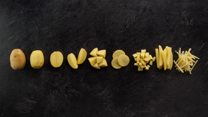 Different cuts of potatoes on a black textured background.