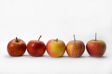 Five red apple in a row on white background