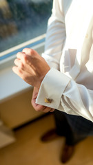 Fototapeta premium Groom wearing cufflink
