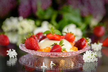 panna cotta with strawberries on a glass table