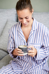 Morning brunette in pajamas with coffee