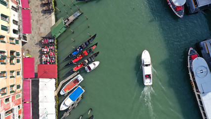 Fototapeta na wymiar Aerial drone top view photo of iconic and unique colourful Gondolas in Grand Canal near Rialto bridge, Venice, Italy
