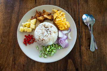 Fried rice with tofu and chicken, top view, dark background. Healthy food concept.