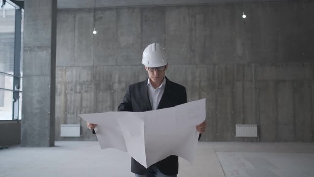 Architect or engineer working, browsing building project indoor of construction site with blueprint plan. businessman worker, man male construction engineers or architects working people