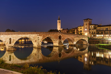 Obraz premium Ponte Pietra over Adige River and city at night. Verona. Italy