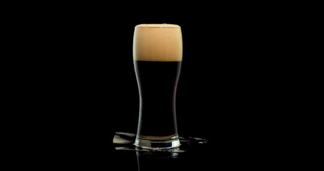 Close up dark beer and beer with foam on a black background